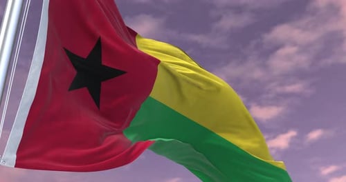 Realistic Guinea-Bissau Flag Waving Against a Cloudy Sky