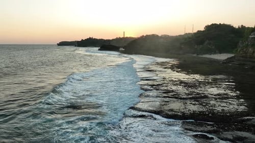 Aerial View of Coastal Cliff and Sea at Sunset