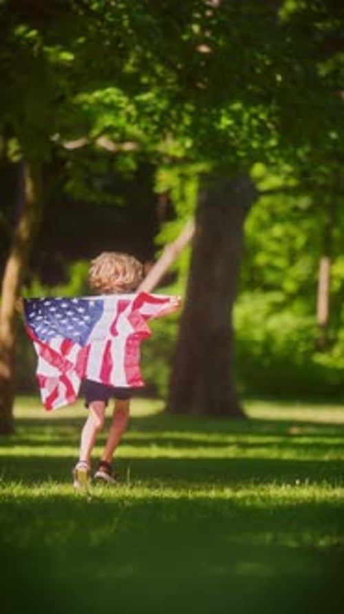 Child Runs with American Flag in a Park