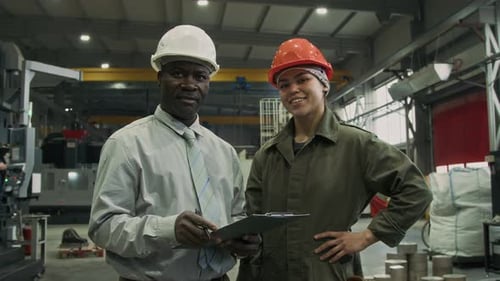 Portrait of Supervisor Posing with Factory Worker in Plant