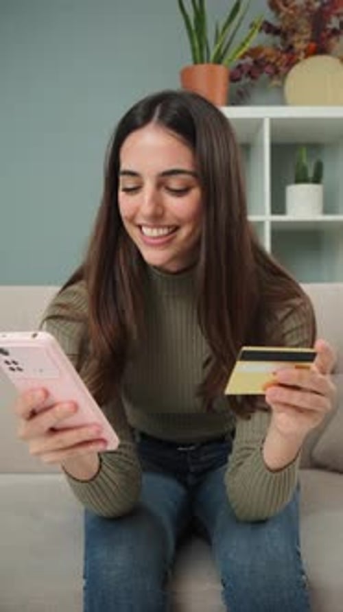 Woman Smiling Holding Phone and Credit Card