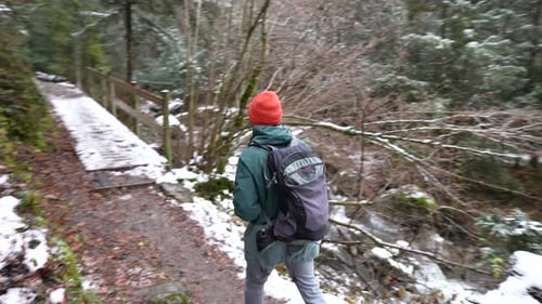 Male Hiker Walking On The Mountain Trail In Winter. panning shot