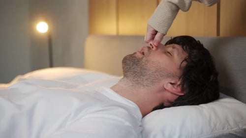 Man Being Woken Up by Pinched Nose