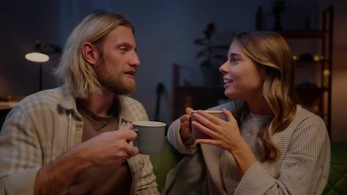 Young Couple Relaxing and Talking Over Coffee
