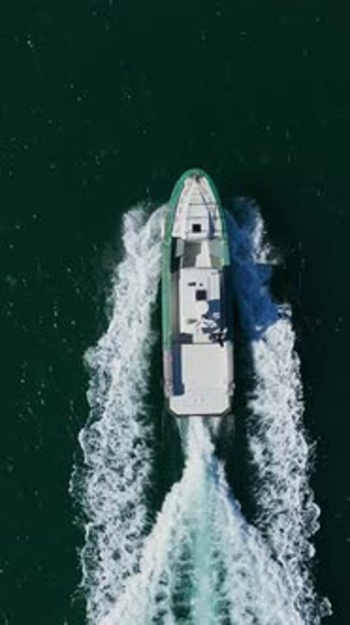 Aerial view to motor yacht floating in the sea