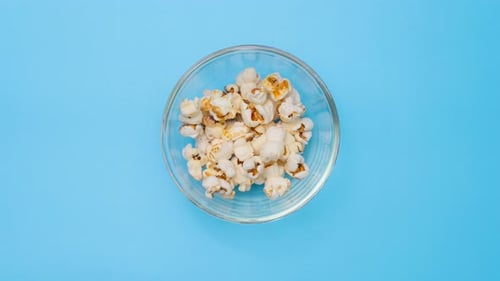 Popcorn Fills Bowl in Overhead Shot
