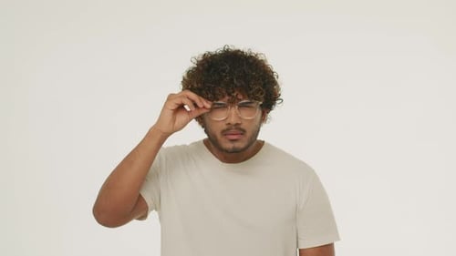 Man Taking off Glasses, Poor Eyesight Concept