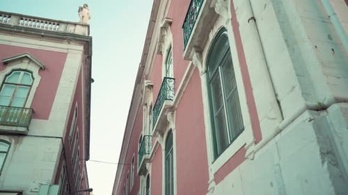 Lisbon typical street facade with big windows at dawn in low angle traveling shot.mp4