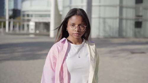 Young Woman Stares at Camera in Urban Setting