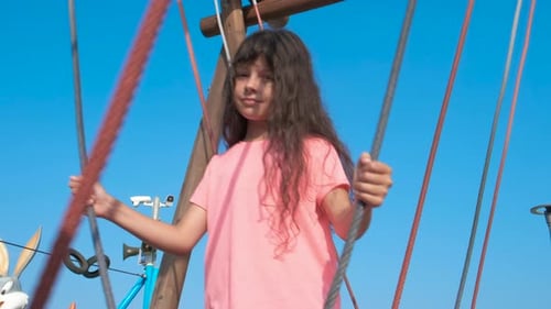 Girl Swinging Happily in the Summer Sunlight