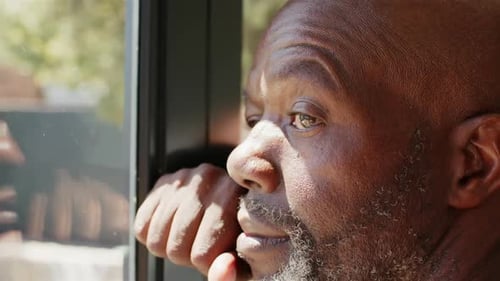 Man Gazing Out Window in Close Up
