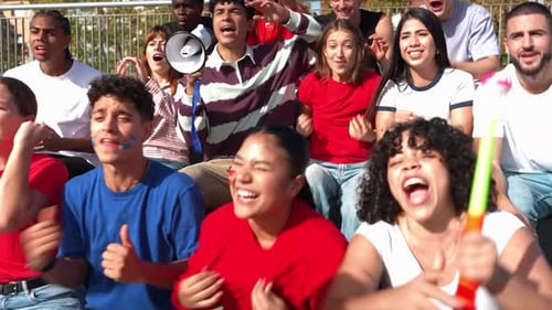 Group of Enthusiastic Supporters Celebrating a Goal in a Stadium
