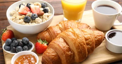 Breakfast Still Life: Croissants, Oatmeal, Juice, and Coffee