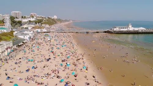 Bournemouth Pier - Aerial over beach, dolly in.