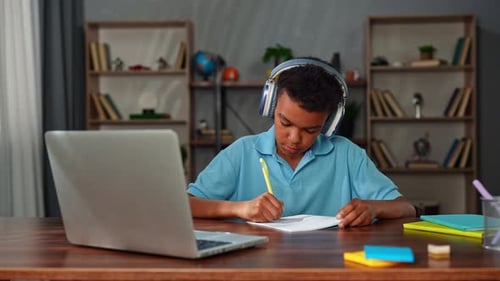 Young African American Child Boy Studying at Home Kid Sits at Desk Attends School Class Online on