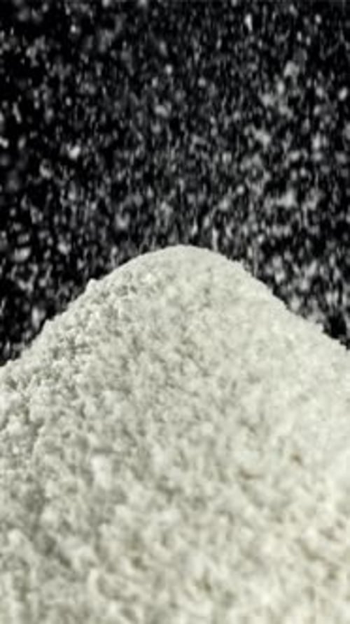 The Flour is Sifted Onto a Mound with Flour Filmed on a Highspeed Camera at 1000 Fps