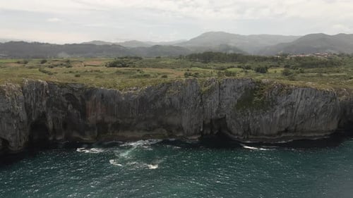 Panoramic Aerial View of Cliffs and Rocks with Mountains in the Background
