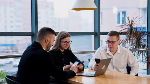 Modern businesspeople having job talk in a spacious office.