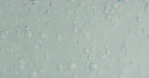 Slow motion macro of micro particles molecules in a liquid are analyzed with microscope for resear