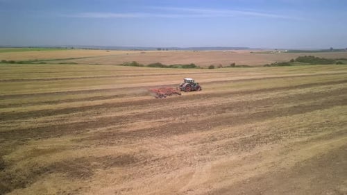 Tractor working on the field doing tillage with cultivator
