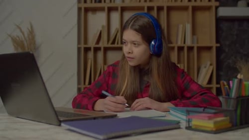 Teen student attending online class at home