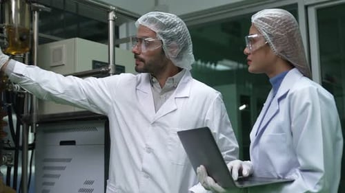 Two Scientist in Professional Uniform Working in Curative Laboratory