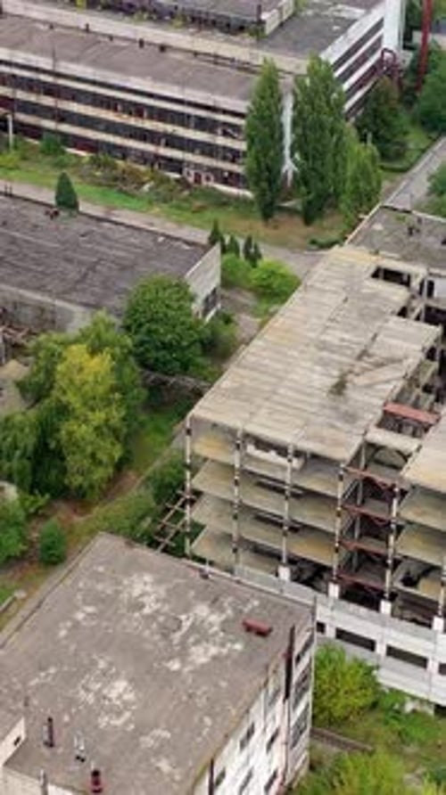 View from above of ruined and abandoned factory. Aerial view of industrial destroyed city buildings