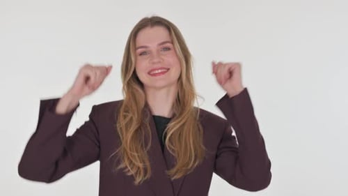 Woman Celebrates Success, Dancing in Studio