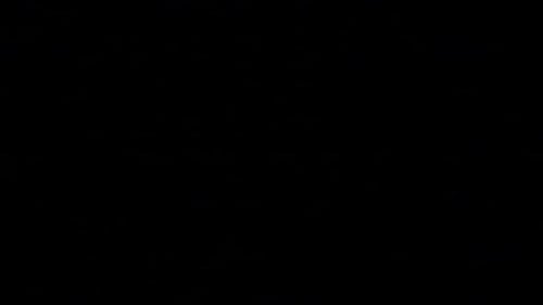 Flashes of lightning in the night sky among thunderclouds.