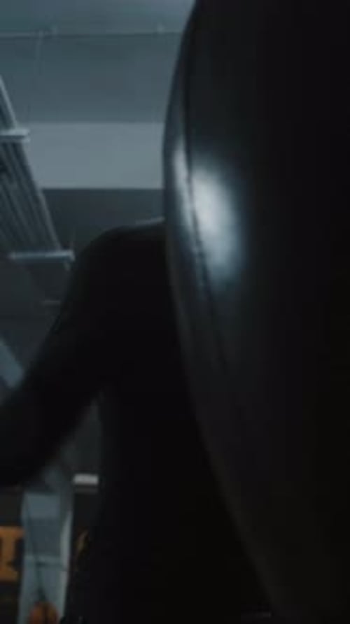 Focused Man Boxing With Punching Bag in Gym