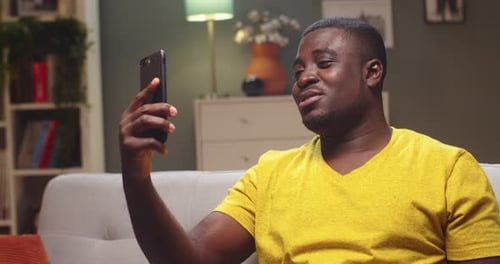 Man Video Chatting on Phone in Living Room