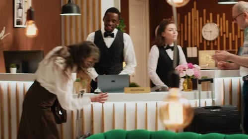Customers Checking In at Hotel Front Desk