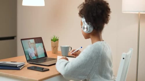 Child Learning Online With Laptop and Headphones