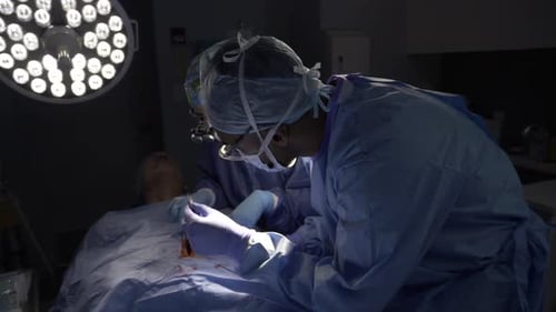 Focused surgeons perform delicate surgery in a modern hospital operating room
