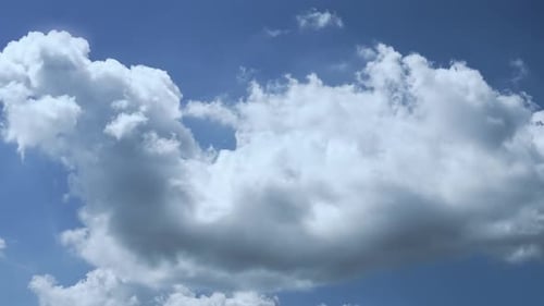 White Clouds Against Blue Sky on Sunny Day