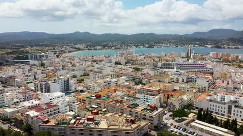 Aerial drone footage of the town of Sant Antoni de Portmany on the west coast of Ibiza in Spain