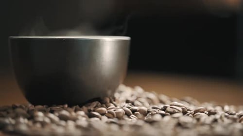 Steaming Mug on Coffee Beans