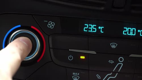 Fingers turn toggle switching climate control in the car from separate to automatic mode