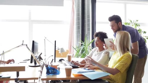 Happy multiethnic business team discussing startup project in modern office