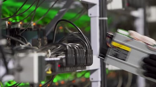 Data Center Diagnostics Technician Installs ASIC Bitcoin Miner on Rack Connects Ethernet Cable