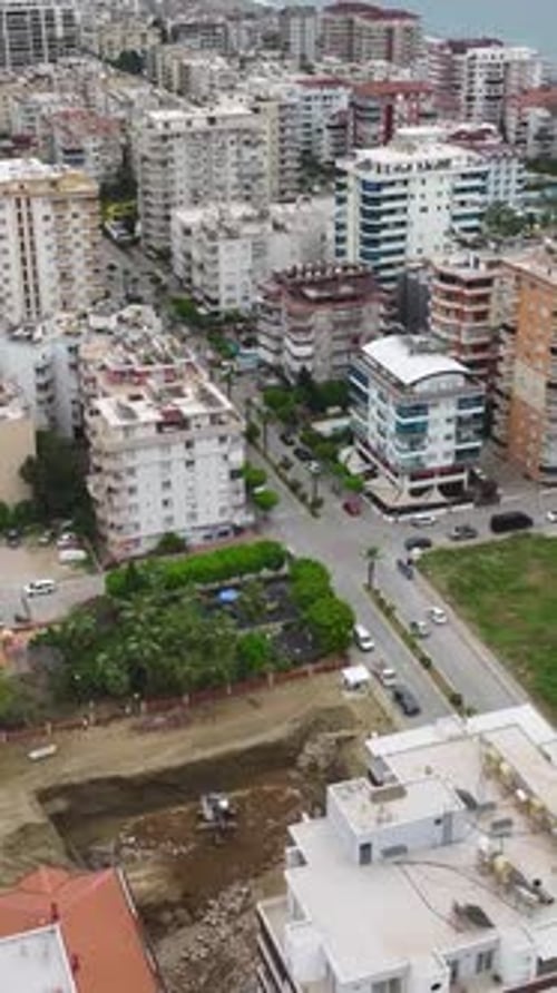 Vertical Video Heavy Equipment and Skilled Workers Working on a Construction Project