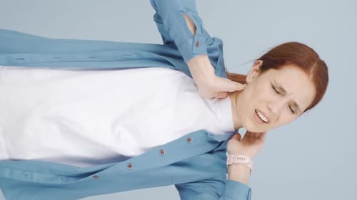 Woman Massaging Neck For Pain Relief