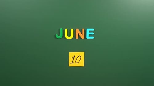 Hand sticking a sticker 10 June calendar day on school board. 10 date of June. Tenth day June
