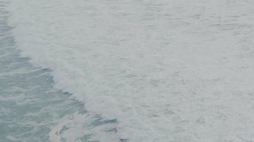 Aerial View of Ocean Waves Crashing on the Shore