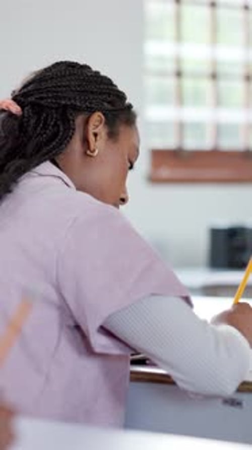 Student, education and girl writing in high school for exam assessment, evaluation quiz and essay