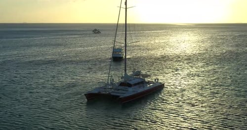 Palm Beach, Noord, Aruba - June 20 2016: Sailboats In Ocean Along Horizon At Sunset, Aerial Drone