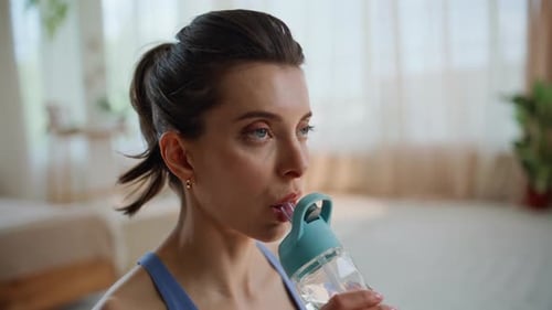 Woman Drinking Water from Reusable Bottle Close Up