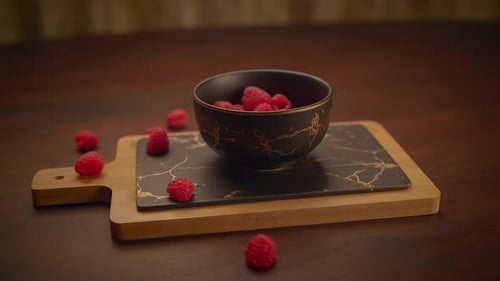 Bowl of Raspberries on Decorative Serving Board