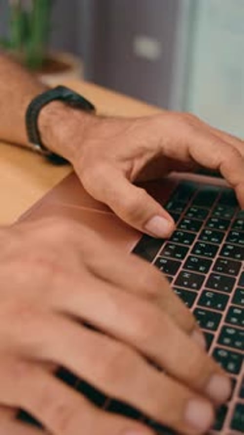 In an Office Workspace Hands are Actively Typing on a Laptop Keyboard Engaged in Work