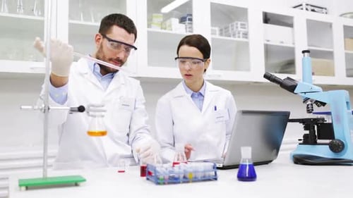 Scientists Working Together in Laboratory Analyzing Data